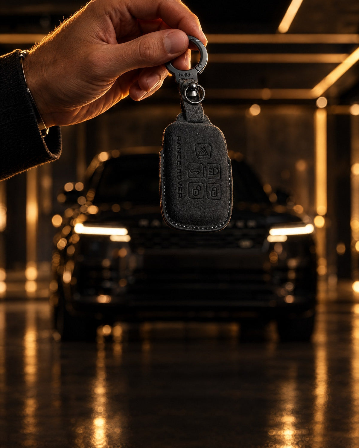 Black suede Range Rover key cover in front of a Range Rover